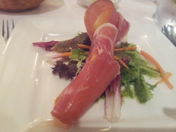 prosciutto - parma ham wrapped over rock melon with mesclun salad