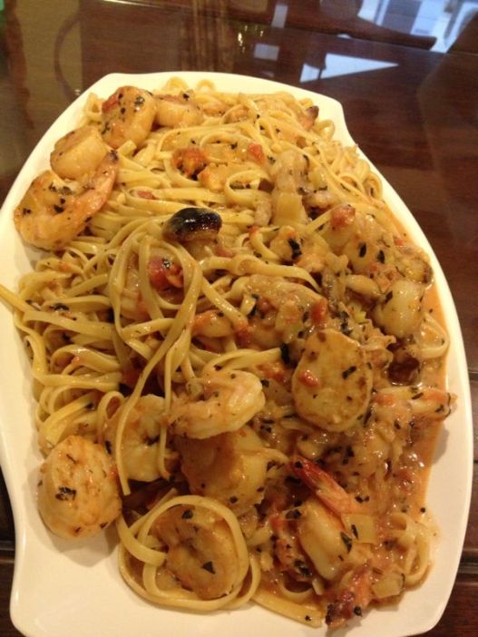 crab linguine in pink sauce with medium prawns & pan-seared scallops