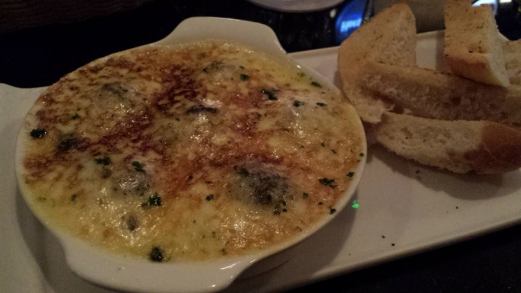 herb escargot covered in baked cheese