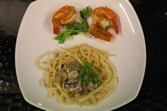 pan-fried prawns served with fungi linguine