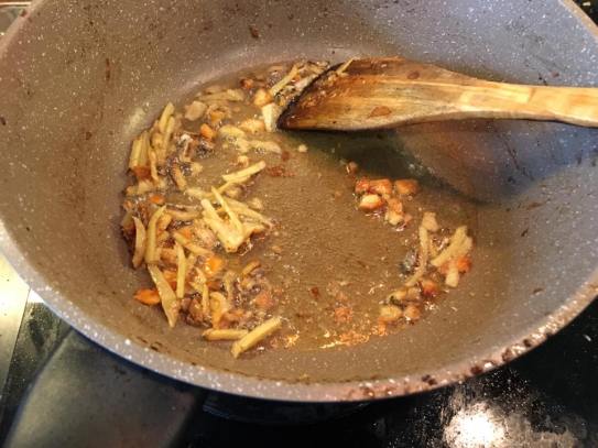 frying-sliced-ginger-salted-fish-before-adding-chopped-garlic