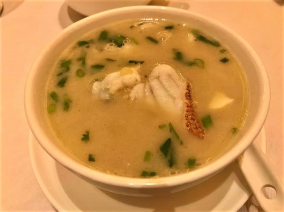 poached garoupa with crispy rice in seafood lobster broth